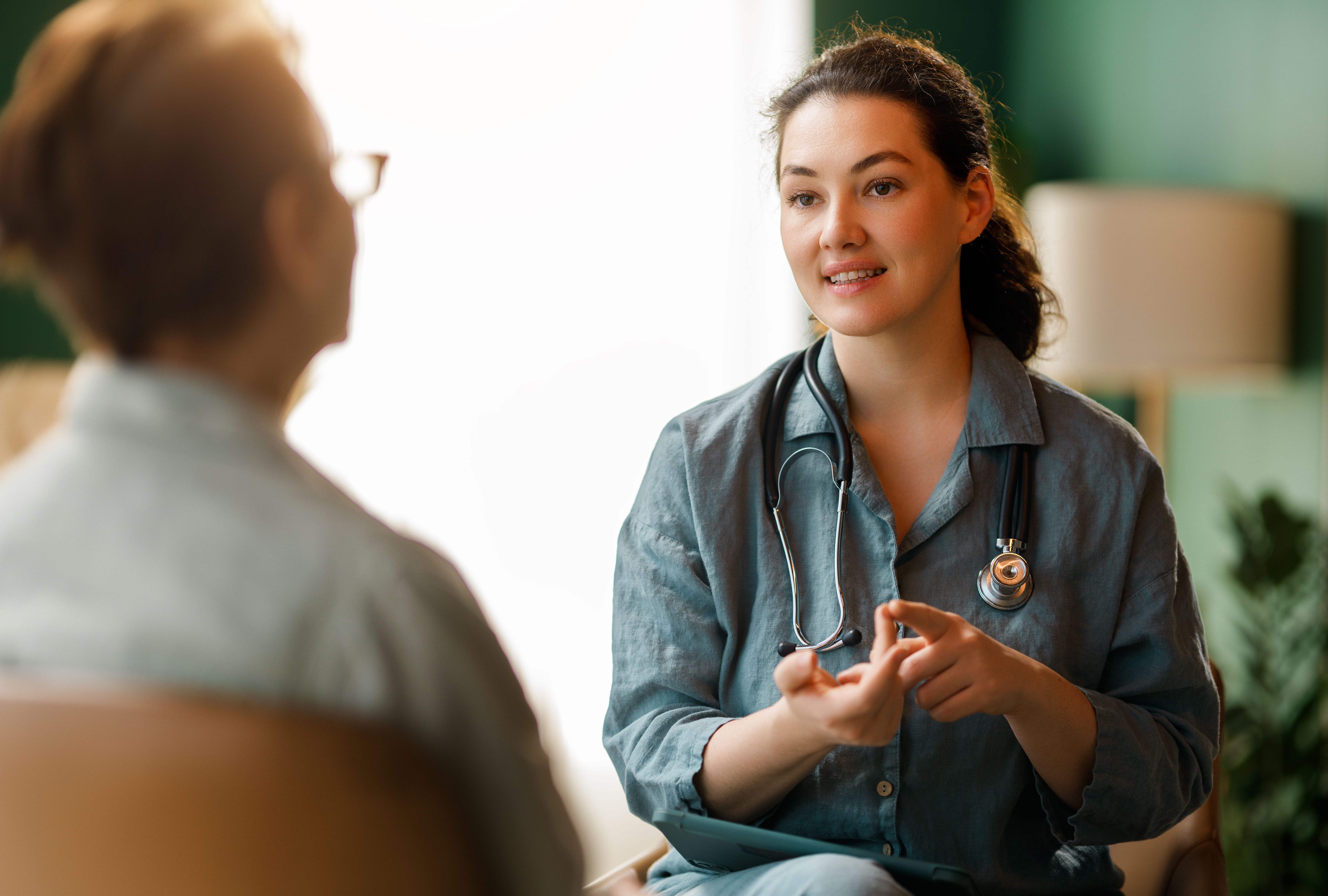 Female patient and a doctor talking in hospital.